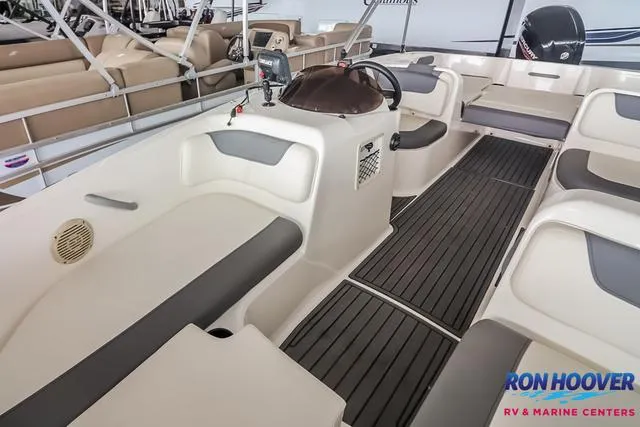 Slide: The Image of 2020 Bayliner Element E18 boat interior with seating and steering console. - 9