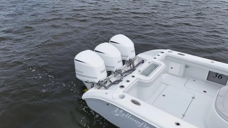 Slide: The Image of 2017 Yellowfin 36 Offshore boat with triple outboard engines on water. - 10