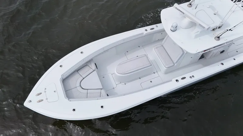 Slide: The Image of 2017 Yellowfin 36 Offshore boat on water, aerial view, sleek design, spacious deck. - 13