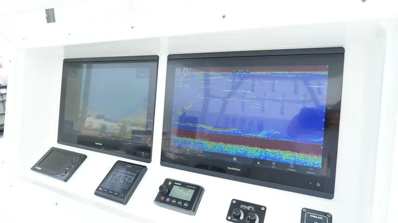 Slide: The Image of Dashboard of a 2017 Yellowfin 36 Offshore boat with navigation screens and controls. - 16