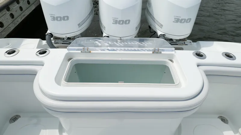 Slide: The Image of 2017 Yellowfin 36 Offshore boat with triple 300 horsepower engines and open storage compartment. - 26