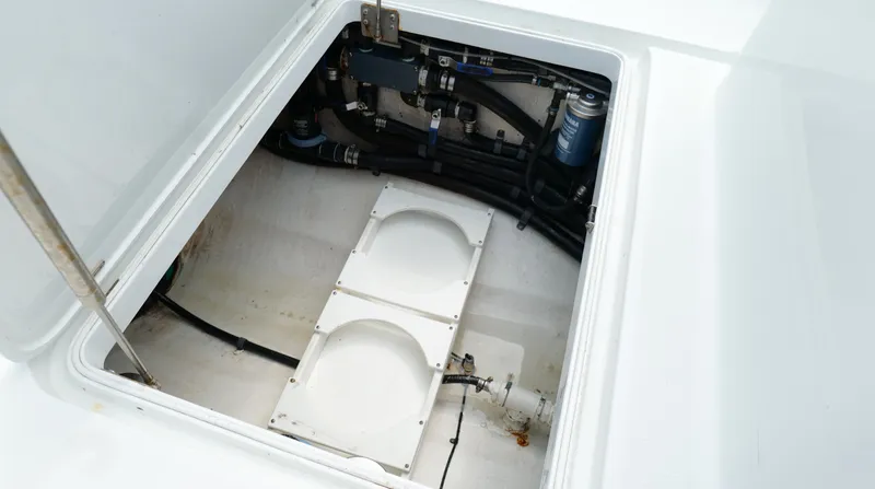 Slide: The Image of 2017 Yellowfin 36 Offshore boat compartment with visible wiring and components. - 33