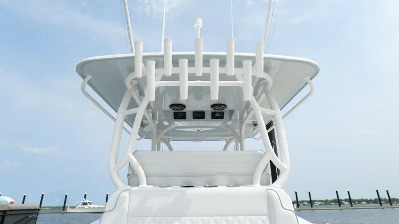 Slide: The Image of 2017 Yellowfin 36 Offshore boat, rear view, showcasing fishing rod holders and sleek design. - 35