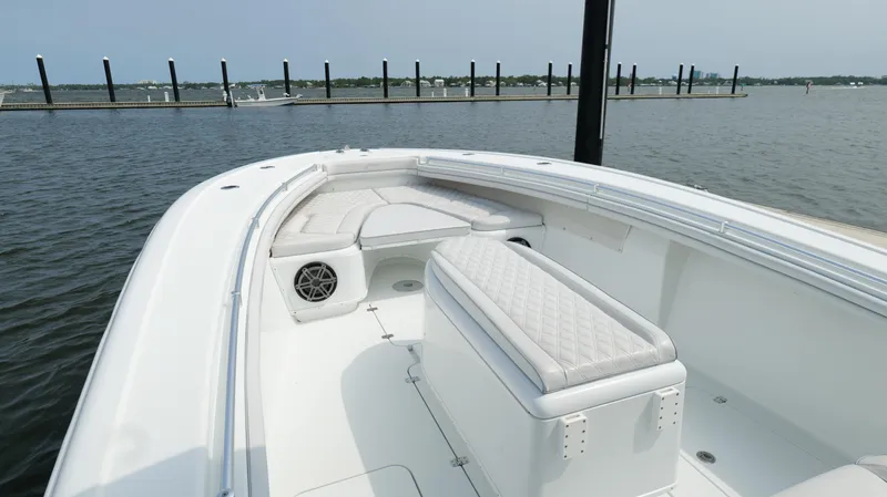 Slide: The Image of 2017 Yellowfin 36 Offshore boat interior with seating, docked by calm waters. - 36