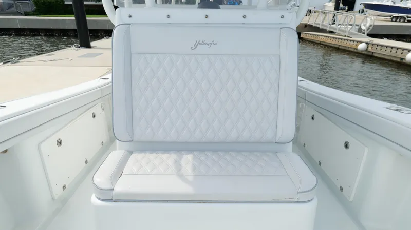 Slide: The Image of 2017 Yellowfin 36 Offshore boat with white diamond-stitched seating at a marina. - 41