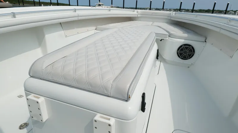 Slide: The Image of 2017 Yellowfin 36 Offshore boat interior with cushioned seating and speaker. - 44
