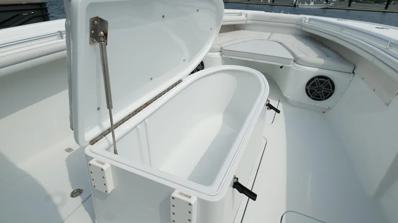 Slide: The Image of 2017 Yellowfin 36 Offshore boat with open storage compartment and seating area. - 45
