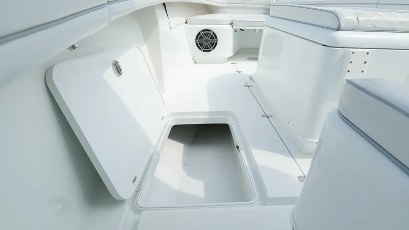 Slide: The Image of 2017 Yellowfin 36 Offshore boat interior with open storage compartment and speaker. - 49