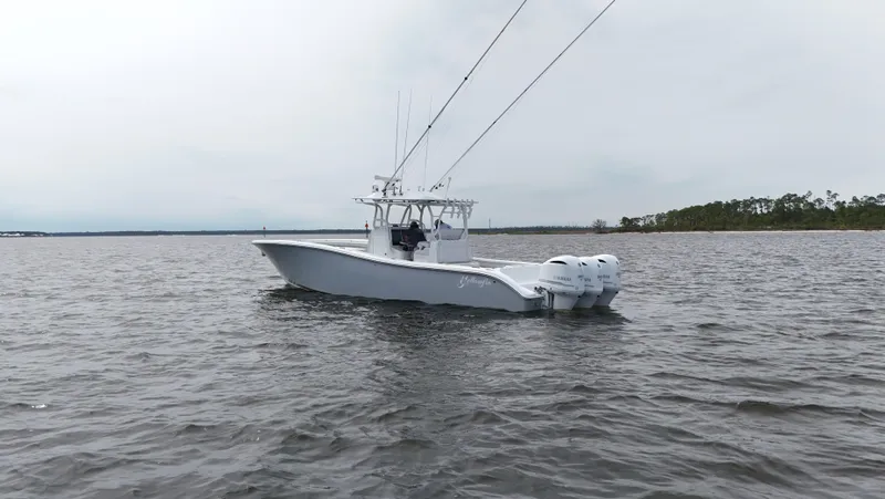 Slide: The Image of 2017 Yellowfin 36 Offshore boat on calm water, featuring triple outboard engines. - 6