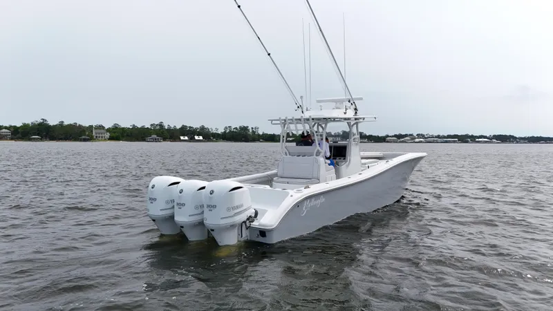 Slide: The Image of 2017 Yellowfin 36 Offshore boat with triple engines on a calm waterway. - 9