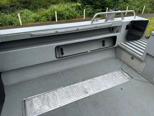 Slide: The Image of 2017 Duckworth Pacific Pro 22' boat interior with storage compartments and metal flooring. - 11