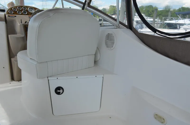 Slide: The Image of 2001 Bayliner 2655 Ciera boat interior with white seating and control panel. - 13