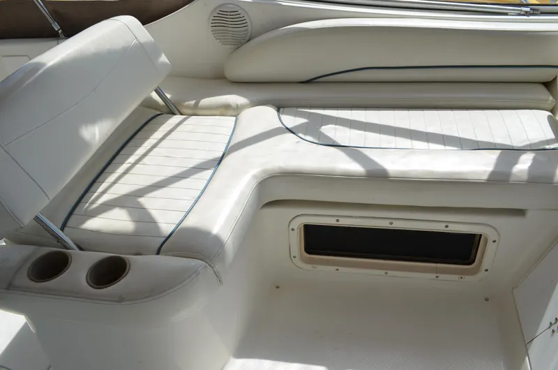 Slide: The Image of 2001 Bayliner 2655 Ciera boat interior with white seating and cup holders. - 15