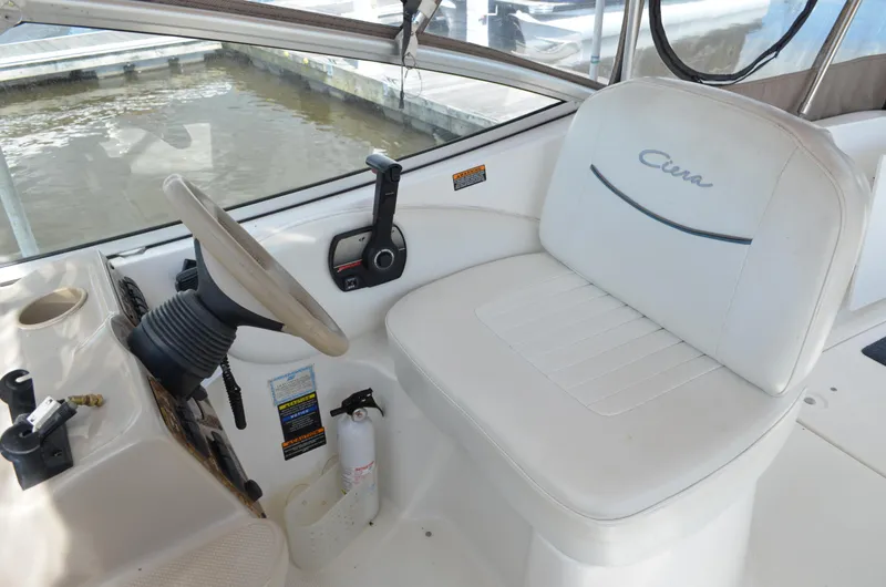 Slide: The Image of 2001 Bayliner 2655 Ciera boat cockpit with steering wheel and control panel. - 17
