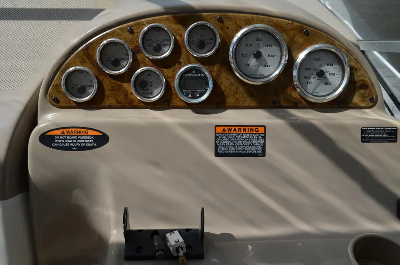 Slide: The Image of Dashboard of a 2001 Bayliner 2655 Ciera boat with gauges and warning labels. - 19