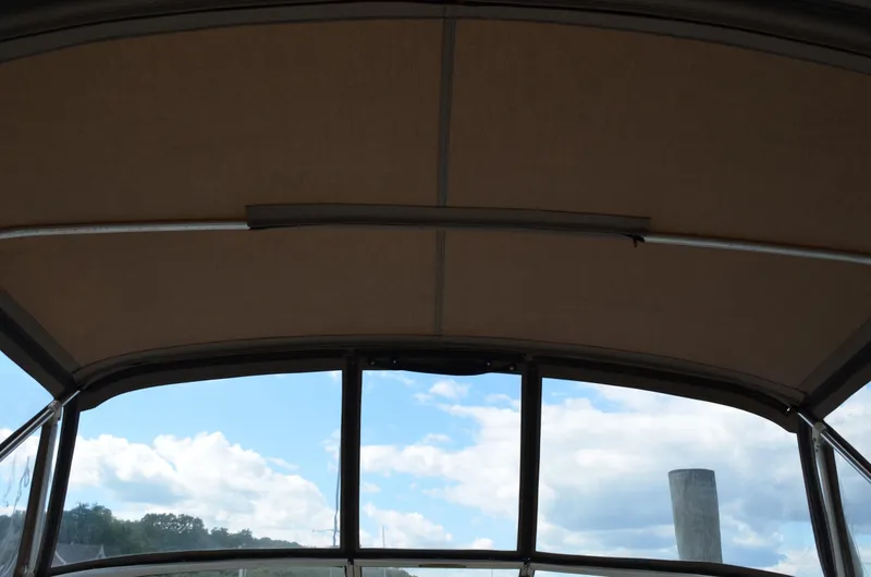 Slide: The Image of 2001 Bayliner 2655 Ciera boat canopy with a view of the sky and clouds. - 21