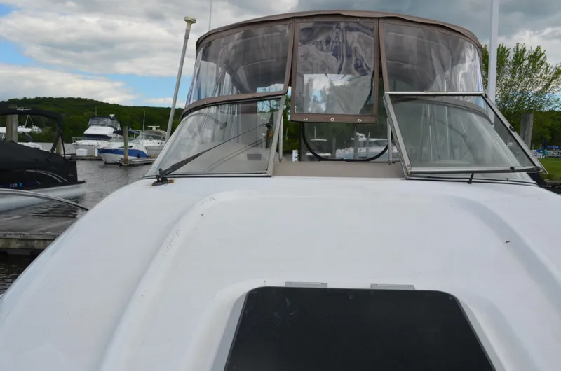 Slide: The Image of 2001 Bayliner 2655 Ciera boat docked at marina, featuring clear canopy and sleek design. - 25
