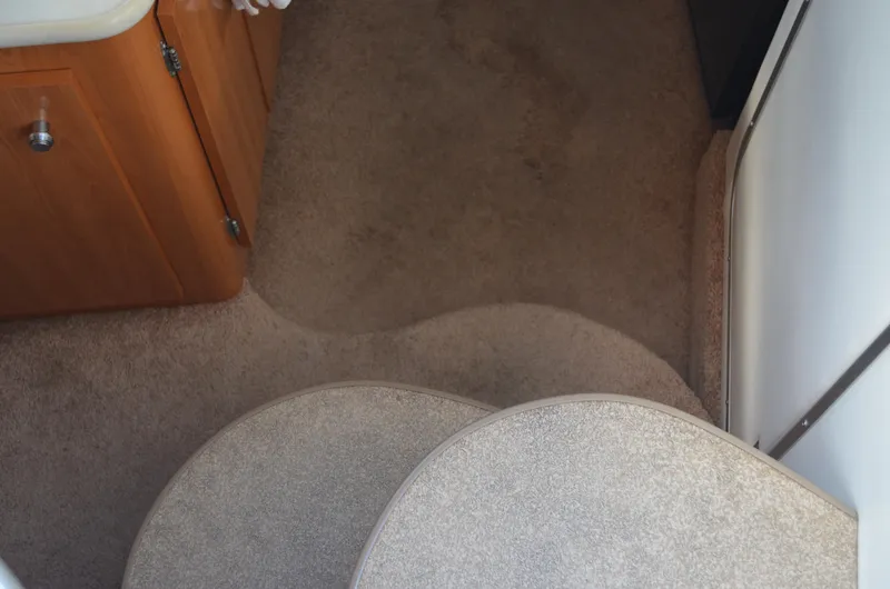 Slide: The Image of Interior view of 2001 Bayliner 2655 Ciera boat with carpeted steps and wooden cabinetry. - 27