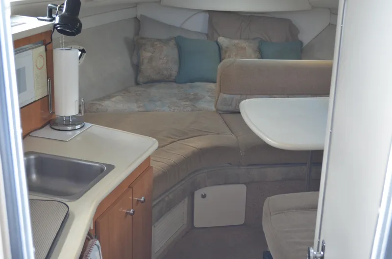 Slide: The Image of Interior of 2001 Bayliner 2655 Ciera boat with kitchenette and cozy seating area. - 28