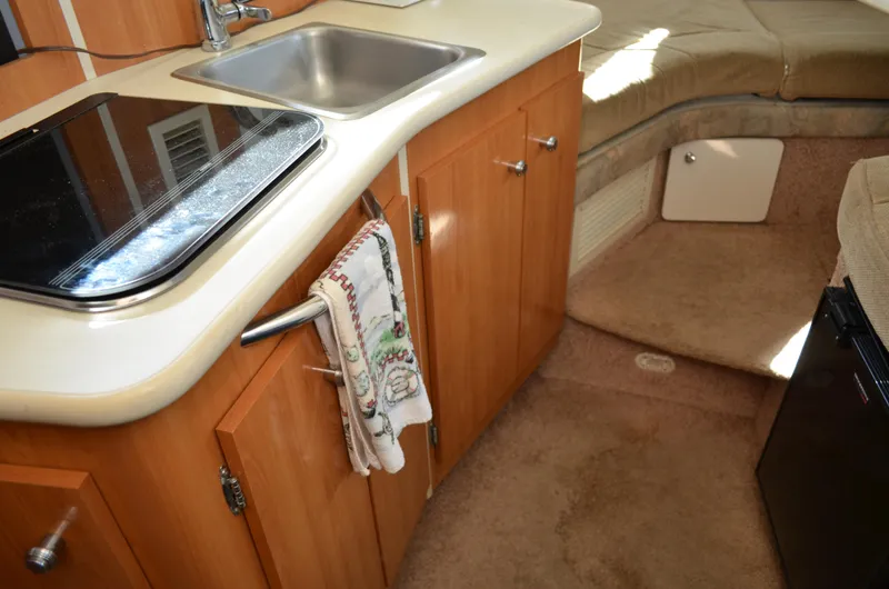 Slide: The Image of 2001 Bayliner 2655 Ciera interior with kitchenette, sink, and seating area. - 29