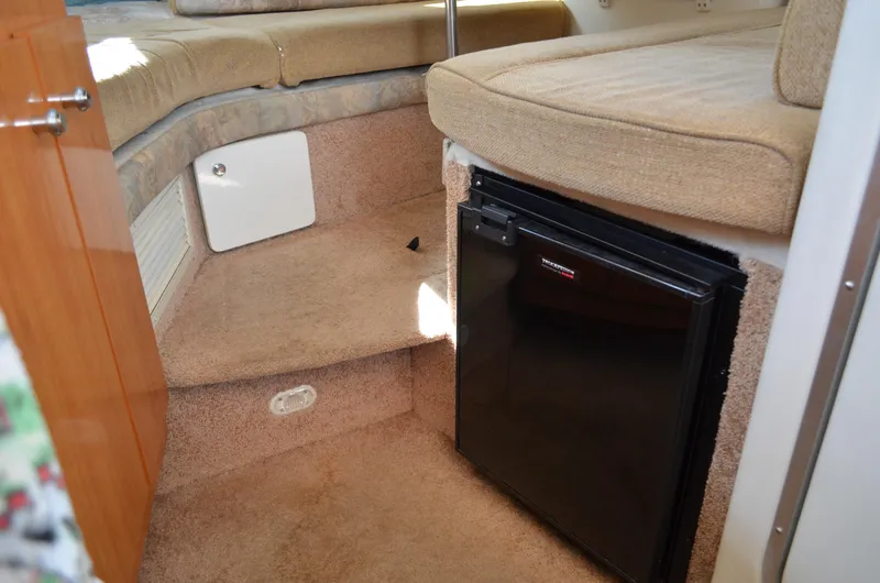 Slide: The Image of Interior of 2001 Bayliner 2655 Ciera boat with compact fridge and seating area. - 42