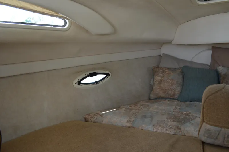 Slide: The Image of 2001 Bayliner 2655 Ciera cabin interior with cozy bedding and porthole window. - 43