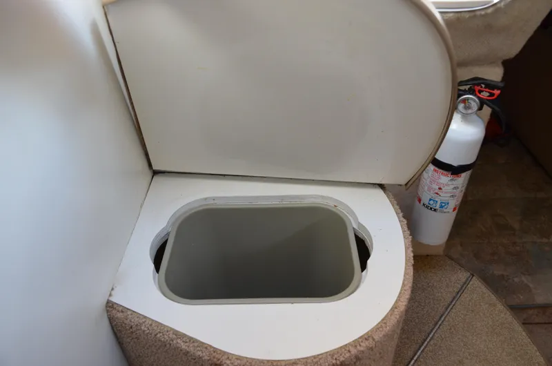 Slide: The Image of 2001 Bayliner 2655 Ciera boat interior with open storage compartment and fire extinguisher. - 46