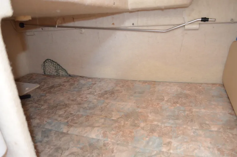 Slide: The Image of 2001 Bayliner 2655 Ciera cabin interior with patterned flooring and storage space. - 49