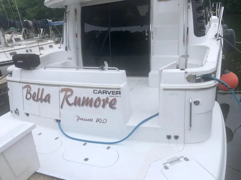 Slide: The Image of 2000 Carver 450 Voyager Pilothouse yacht, named "Bella Rumore," docked with visible deck and equipment. - 15
