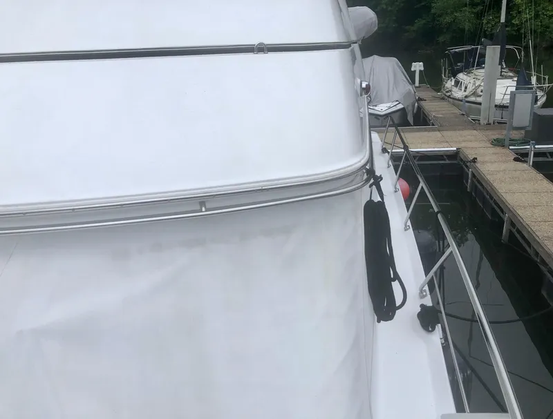 Slide: The Image of 2000 Carver 450 Voyager Pilothouse yacht docked at marina, side view. - 17