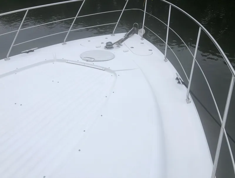 Slide: The Image of Bow of 2000 Carver 450 Voyager Pilothouse yacht with railing and anchor. - 19