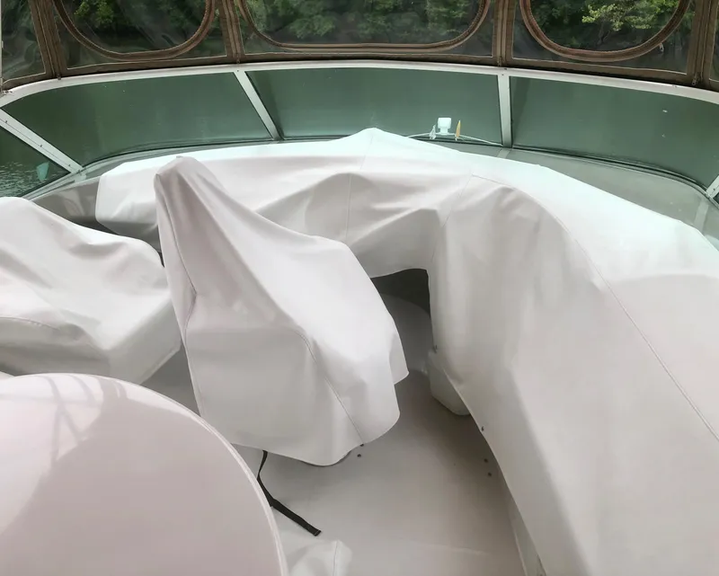 Slide: The Image of 2000 Carver 450 Voyager Pilothouse interior with covered seating and helm area. - 23