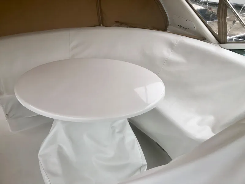 Slide: The Image of White seating area with round table on 2000 Carver 450 Voyager Pilothouse yacht. - 24