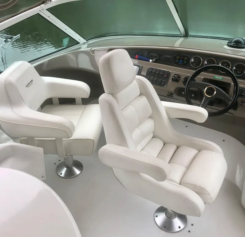 Slide: The Image of Pilothouse interior of 2000 Carver 450 Voyager with white captain chairs and control panel. - 26