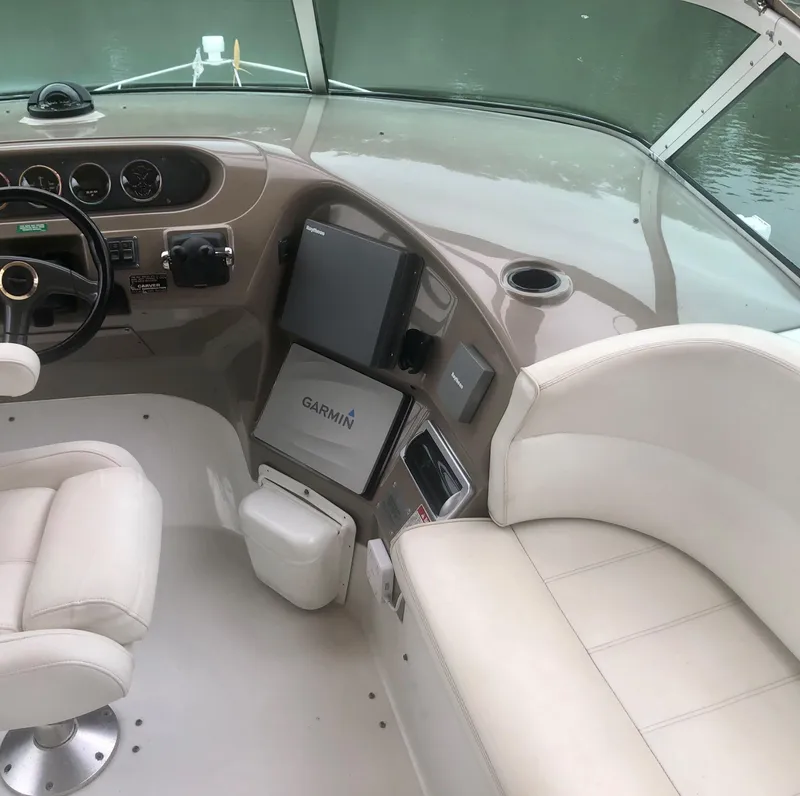 Slide: The Image of Interior of 2000 Carver 450 Voyager Pilothouse with steering wheel and Garmin navigation system. - 28