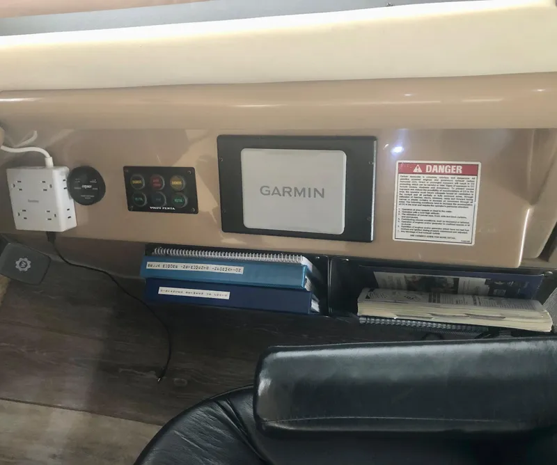 Slide: The Image of Control panel of 2000 Carver 450 Voyager Pilothouse with Garmin device and warning label. - 46