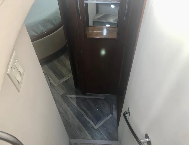 Slide: The Image of Interior hallway of 2000 Carver 450 Voyager Pilothouse with wood flooring and bedroom view. - 49