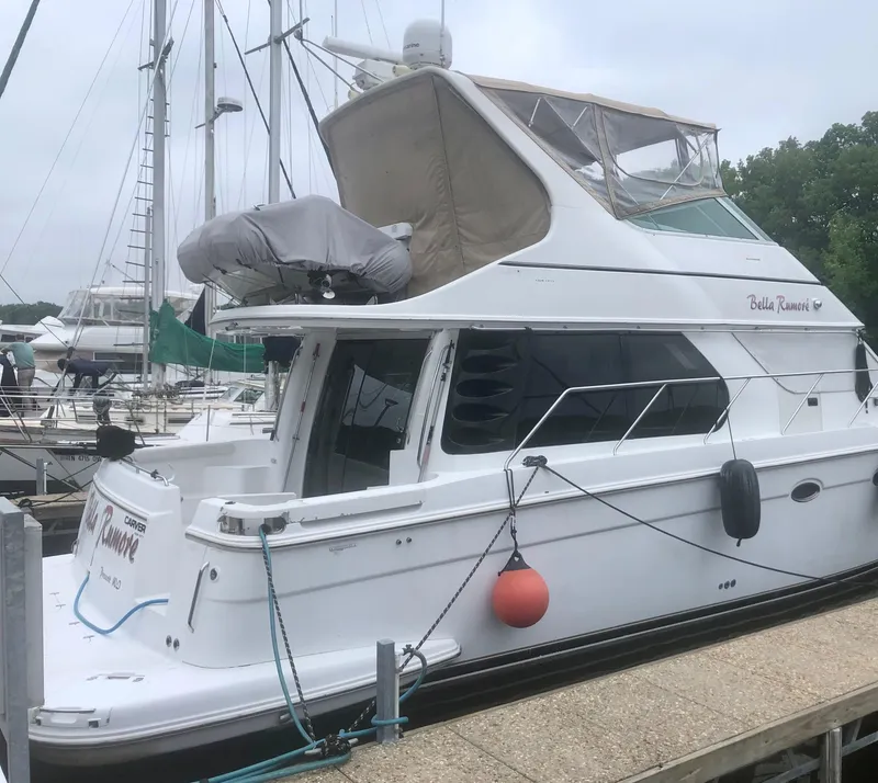 Slide: The Image of 2000 Carver 450 Voyager Pilothouse yacht docked at marina. - 7