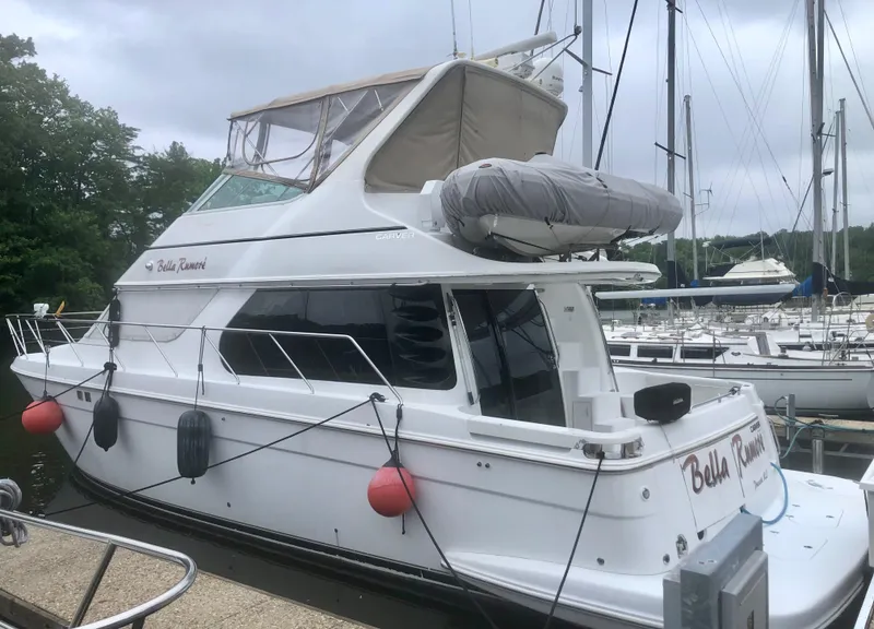 Slide: The Image of 2000 Carver 450 Voyager Pilothouse yacht docked at marina, side view. - 10