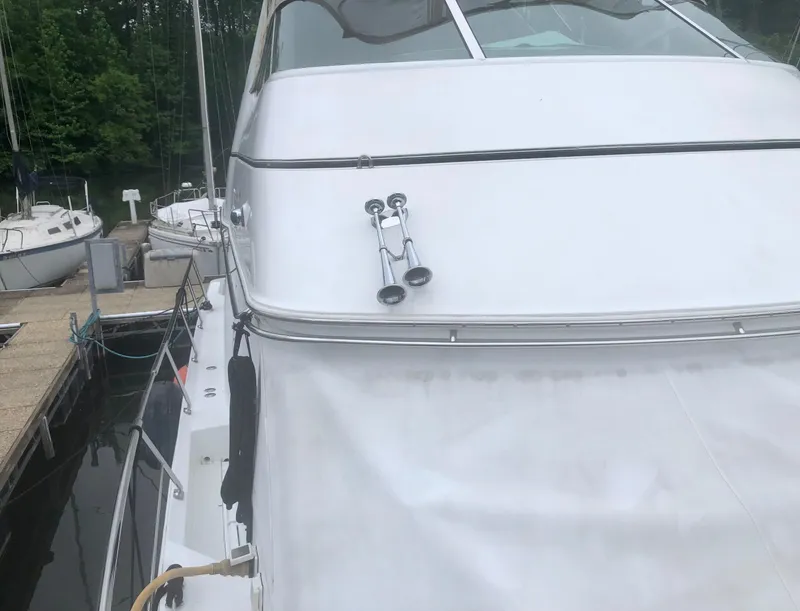 Slide: The Image of 2000 Carver 450 Voyager Pilothouse yacht docked at marina. - 18