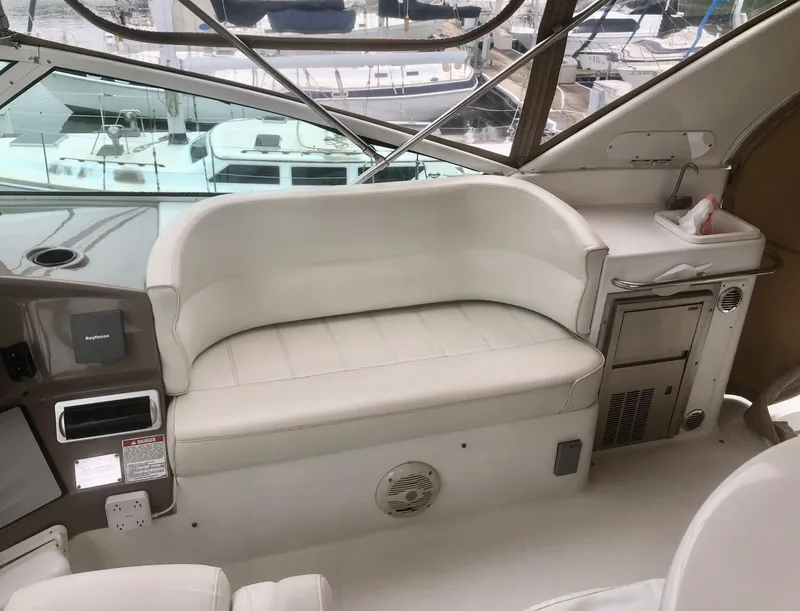Slide: The Image of Interior of 2000 Carver 450 Voyager Pilothouse with white seating and control panel. - 25