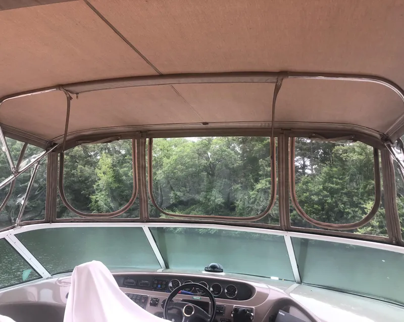 Slide: The Image of Pilothouse interior of 2000 Carver 450 Voyager, featuring helm and panoramic windows. - 33