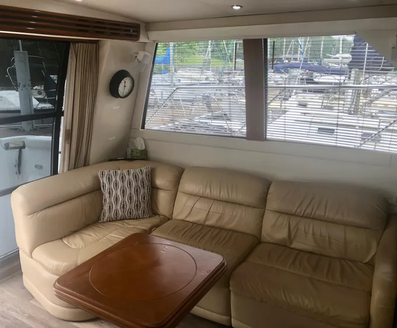 Slide: The Image of Interior of 2000 Carver 450 Voyager Pilothouse with leather seating and wooden table. - 38