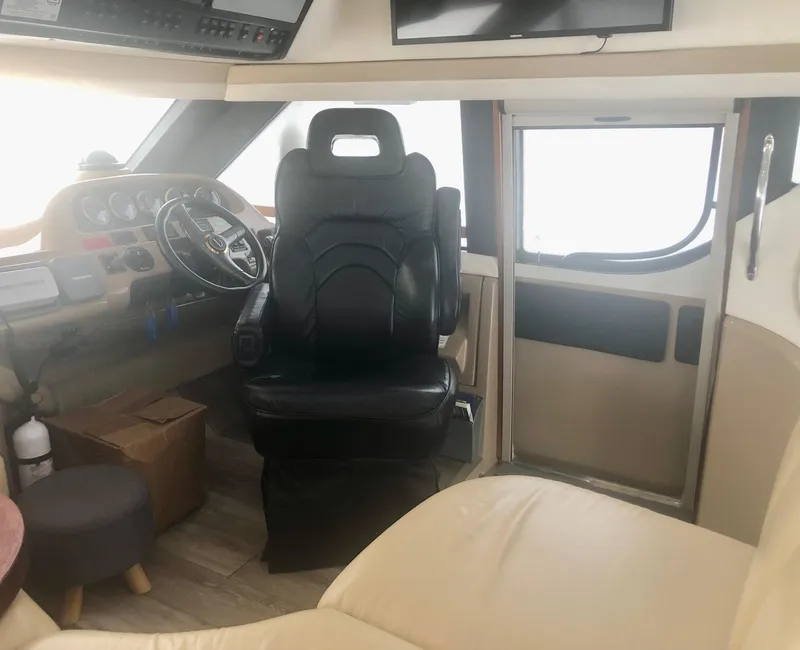 Slide: The Image of Interior of a 2000 Carver 450 Voyager Pilothouse with steering wheel and captain's chair. - 41