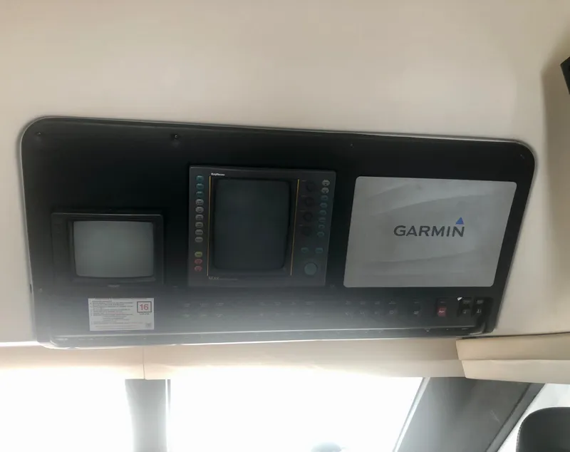 Slide: The Image of Control panel of a 2000 Carver 450 Voyager Pilothouse with Garmin navigation system. - 42