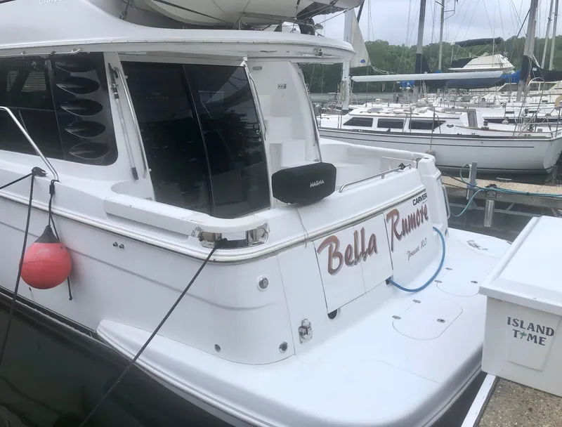 Slide: The Image of Carver 450 Voyager Pilothouse 2000 docked, featuring "Bella Rumore" name on the stern. - 9