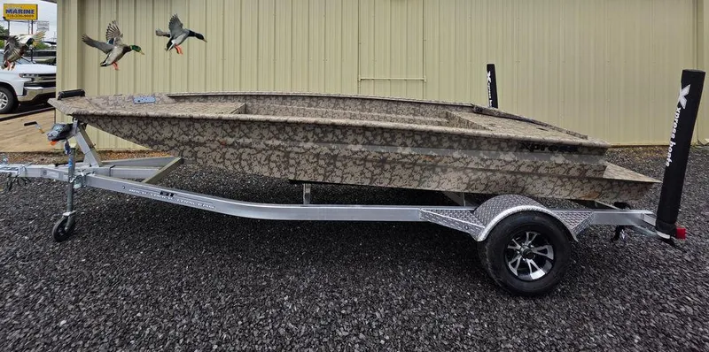 Slide: The Image of 2025 Xpress H18DB boat on trailer, camouflage design, parked outdoors. - 0