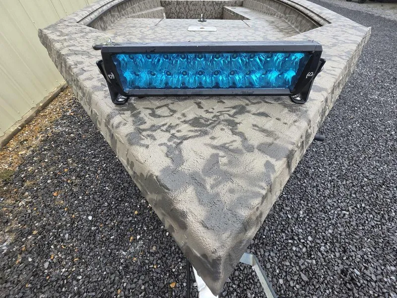 Slide: The Image of 2025 Xpress H18DB boat with blue LED light bar on camo-patterned deck. - 23