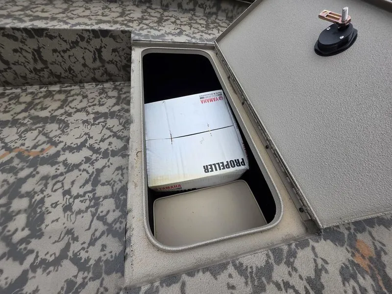 Slide: The Image of Open storage compartment in 2025 Xpress H18DB boat with camo pattern. - 6