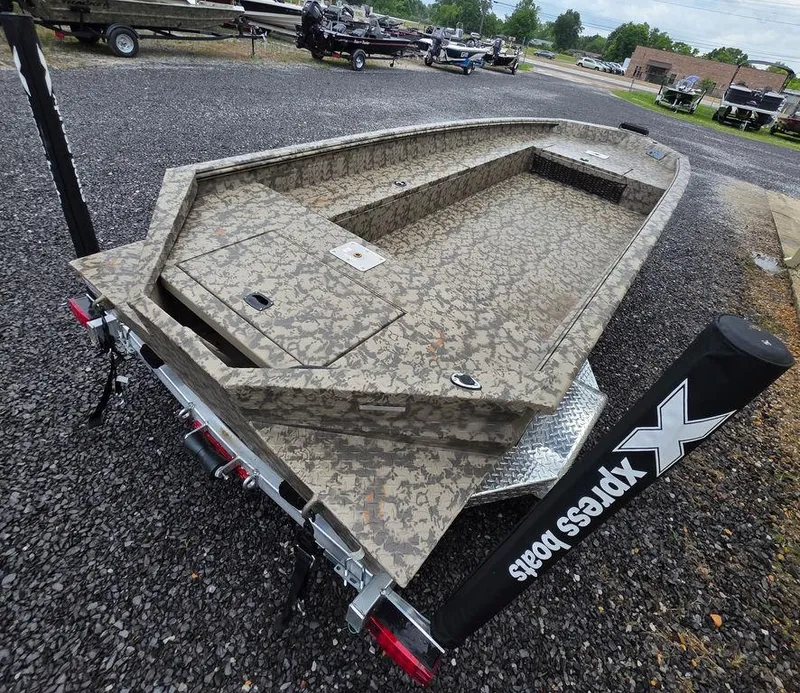 Slide: The Image of 2025 Xpress H18DB boat with camouflage design on a trailer, parked outdoors. - 8